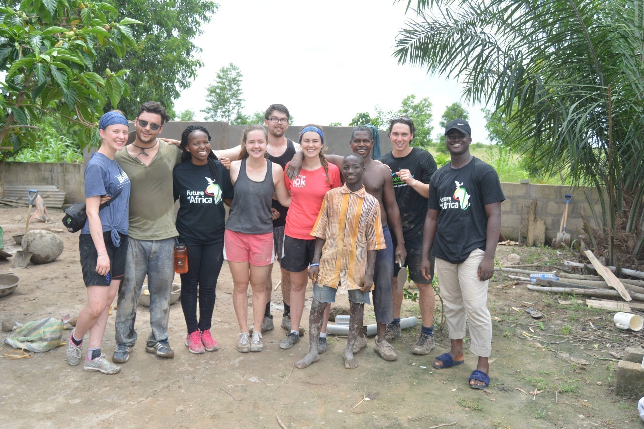 Group of students standing and smiling in Mi Ghana