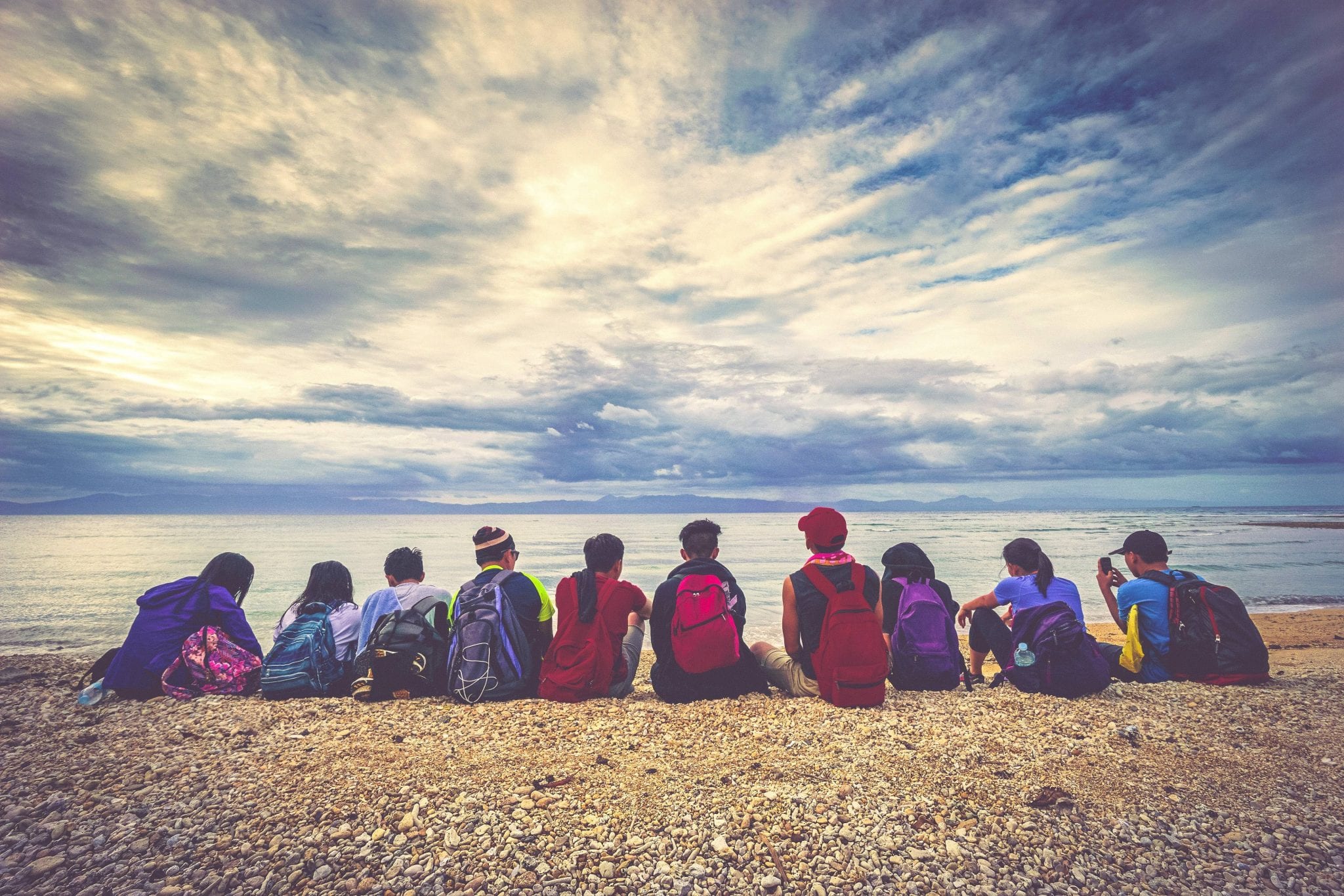 Group of students sitting by the water