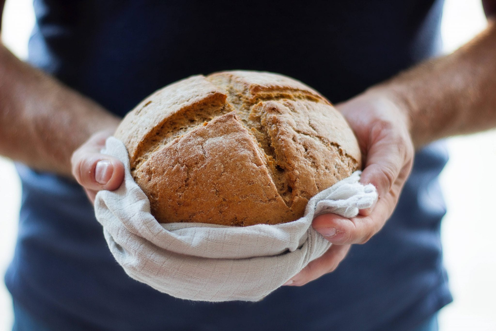 Man holding freshly baked bread